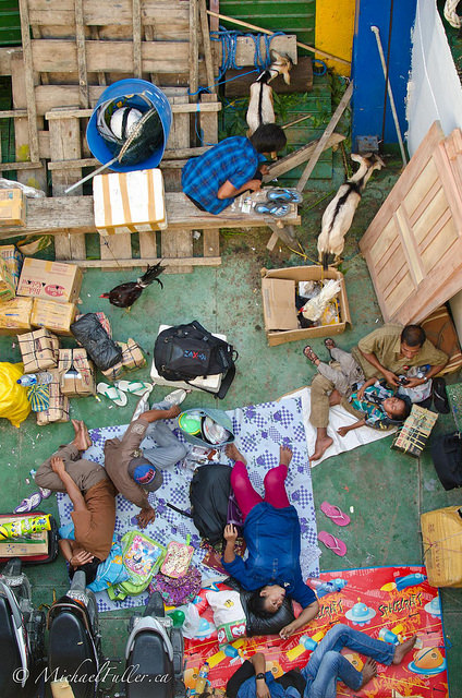 Overloaded ferry: Goats, chickens, parents, children, motorbikes, and more.
