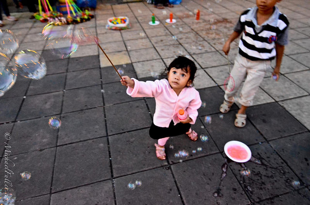 cute kids playing with bubble wands in Bukittinggi