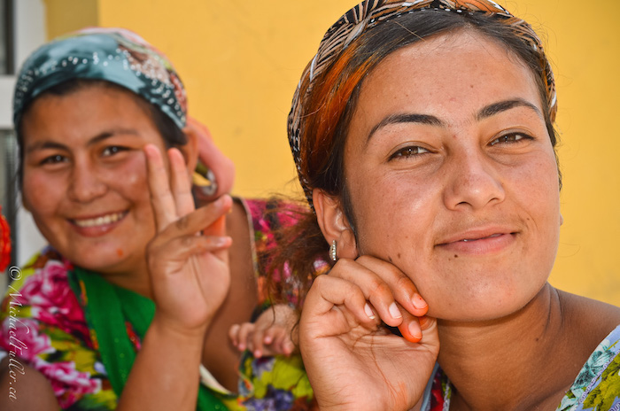 Beautiful, colourful women sell produce in a Khiva market.